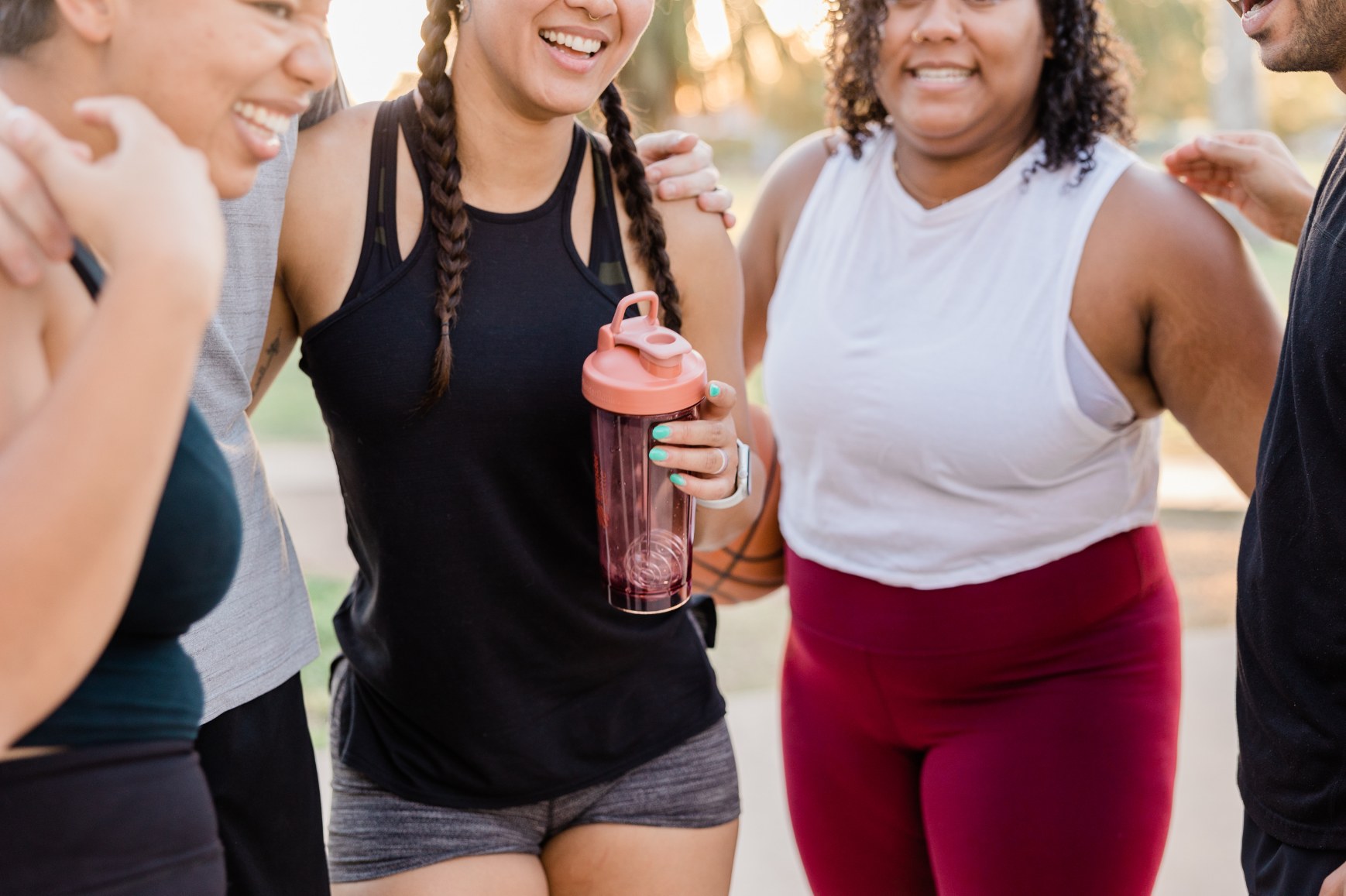 Women laughing together after an outdoor workout
